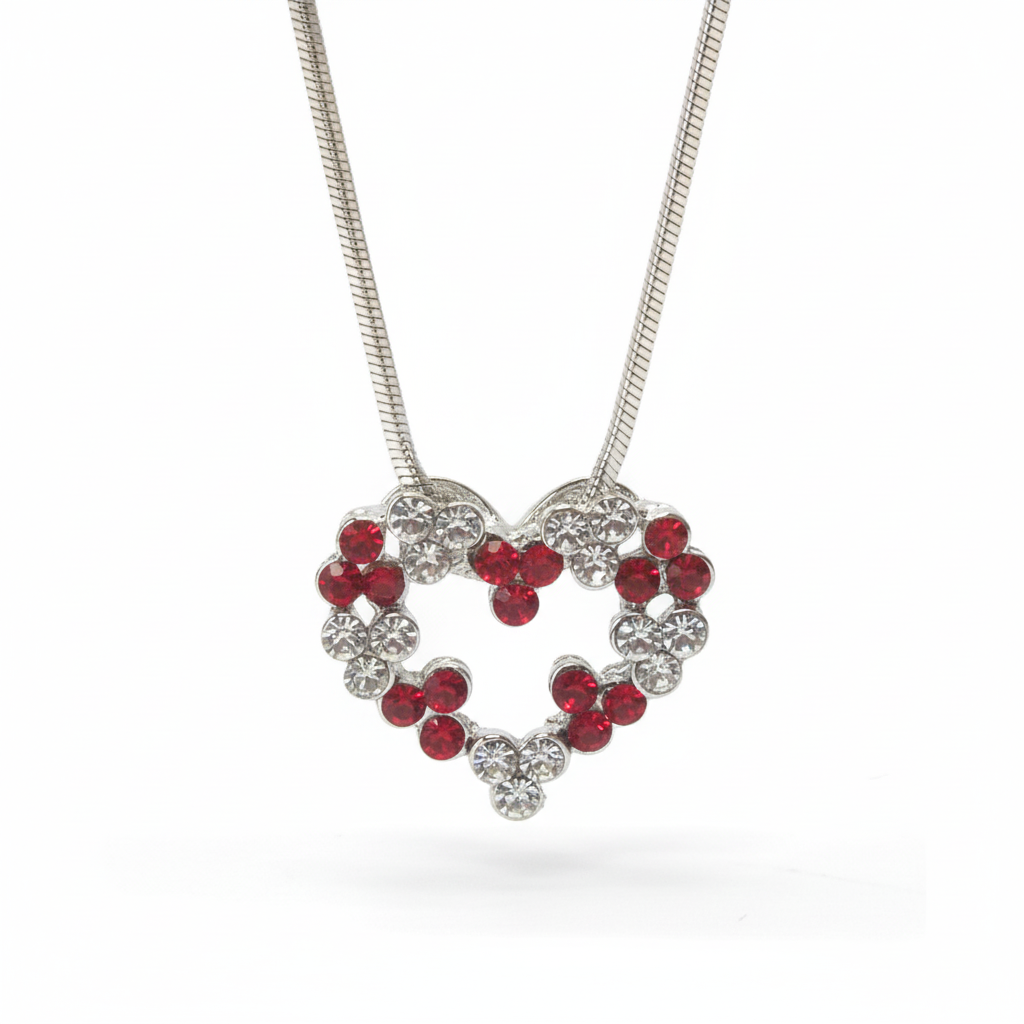 Close-up of white gold crystal heart pendant necklace with red and clear stones